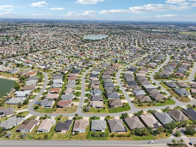 view of property location with a nearby body of water and nearby suburban area
