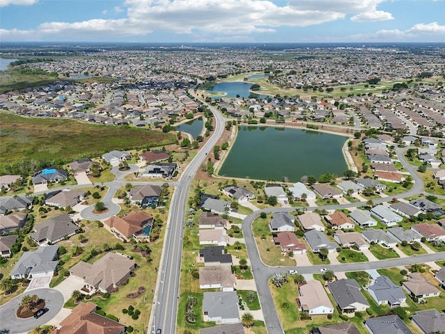 aerial overview of property's location with a large body of water and nearby suburban area