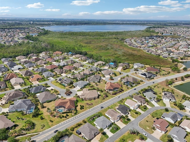 view of property location featuring a large body of water and nearby suburban area
