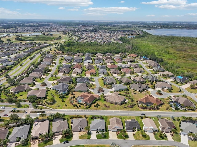 aerial overview of property's location featuring a nearby body of water and nearby suburban area