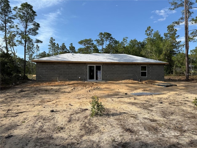 back of property with concrete block siding