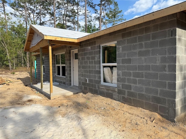 view of property exterior with concrete block siding
