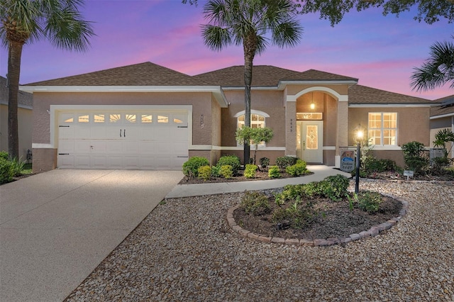 9649 SW 90th St, Ocala, FL 34481 - view of front of home featuring driveway, stucco siding, and an attached garage