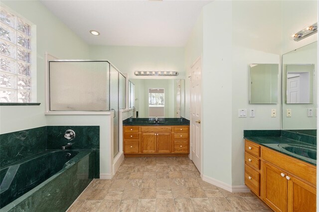 9649 SW 90th St, Ocala, FL 34481 - bathroom with a shower stall, a bath, baseboards, stone finish floors, and two vanities