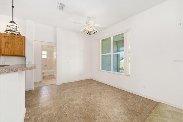 9649 SW 90th St, Ocala, FL 34481 - unfurnished dining area with a ceiling fan, baseboards, and stone finish floors