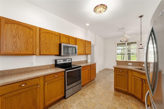 9649 SW 90th St, Ocala, FL 34481 - kitchen with appliances with stainless steel finishes, brown cabinets, hanging light fixtures, and a ceiling fan