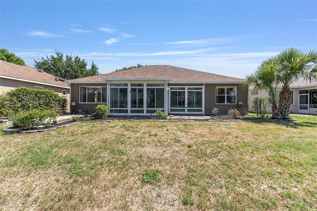 9649 SW 90th St, Ocala, FL 34481 - back of property featuring a sunroom, a yard, and stucco siding