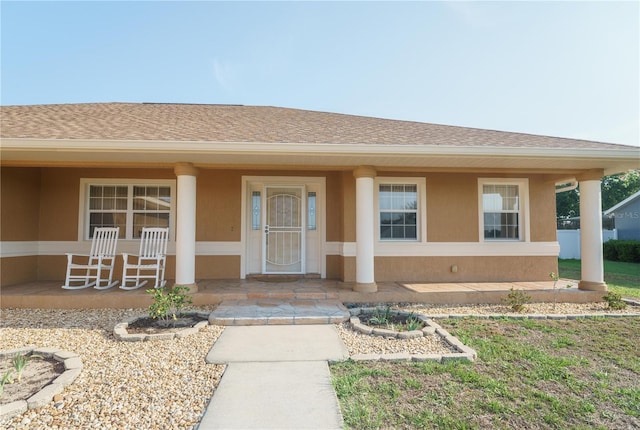 7475 SE 105th Pl, Belleview, FL 34420 - view of exterior entry with a porch and roof with shingles