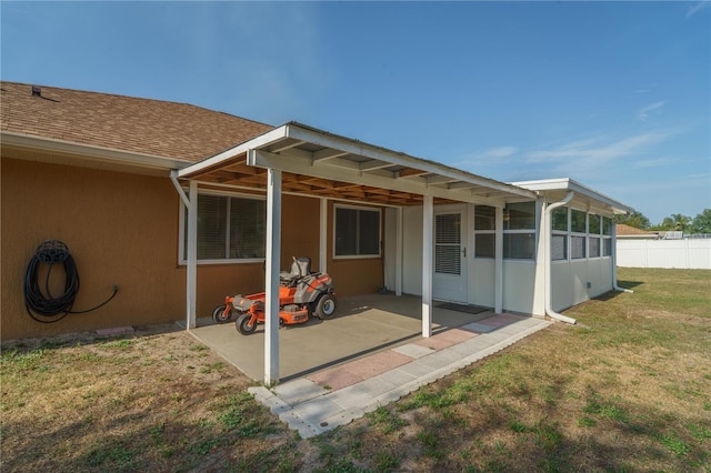 7475 SE 105th Pl, Belleview, FL 34420 - back of house with a patio area, roof with shingles, stucco siding, and a sunroom