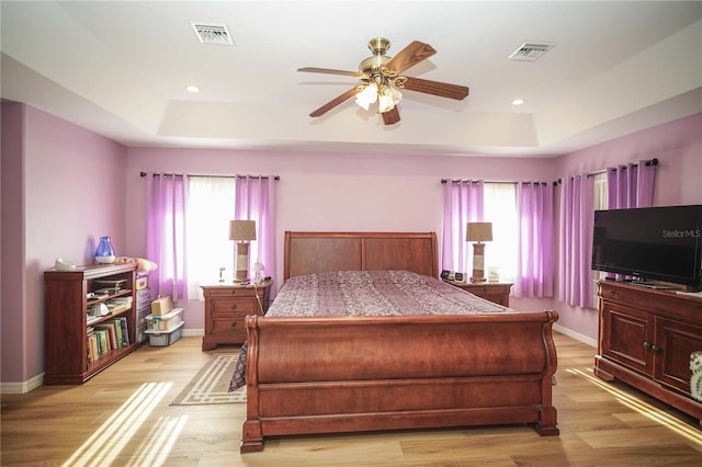 7475 SE 105th Pl, Belleview, FL 34420 - bedroom featuring a raised ceiling, baseboards, light wood-type flooring, a ceiling fan, and recessed lighting