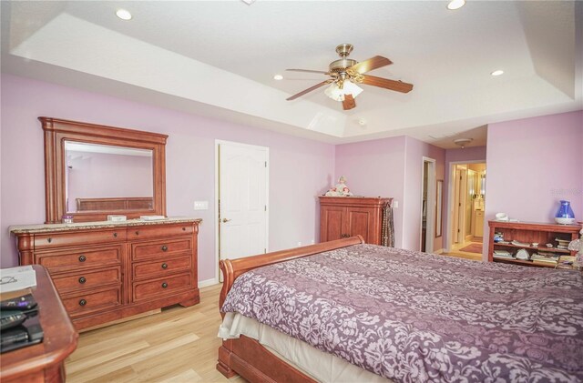 7475 SE 105th Pl, Belleview, FL 34420 - bedroom featuring a tray ceiling, light wood-type flooring, recessed lighting, and a ceiling fan