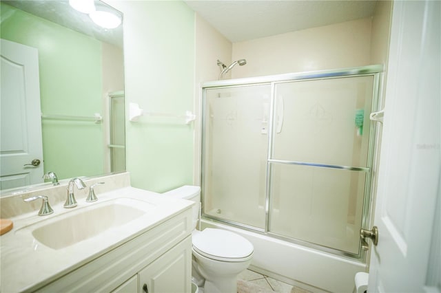 7475 SE 105th Pl, Belleview, FL 34420 - bathroom featuring toilet, combined bath / shower with glass door, vanity, and tile patterned flooring