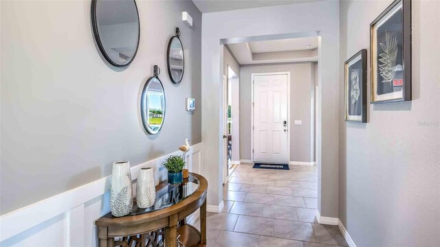4532 SW 56th Pl, Gainesville, FL 32608 - corridor featuring tile patterned flooring, a raised ceiling, and baseboards