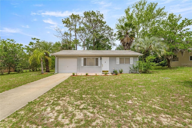 view of front of property with concrete driveway, an attached garage, and a front yard