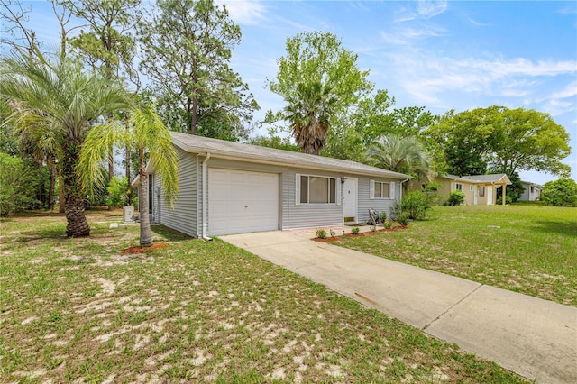 view of front of home with concrete driveway, a front yard, and a garage