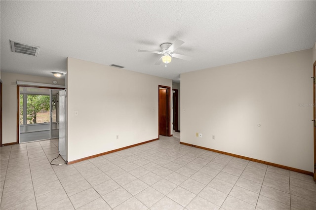 unfurnished room featuring a ceiling fan, a textured ceiling, and baseboards