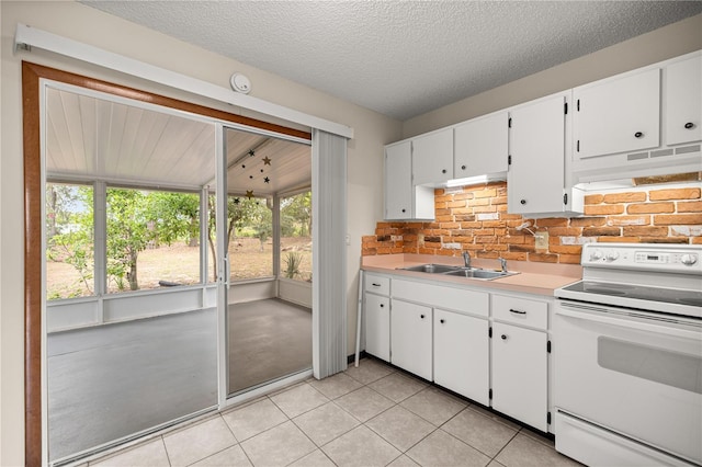 kitchen featuring white electric range oven, a sink, under cabinet range hood, white cabinets, and a textured ceiling