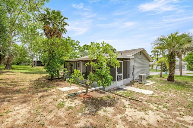 rear view of house with a sunroom and central air condition unit