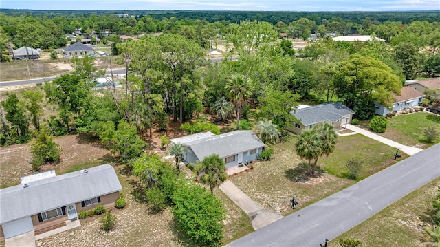 aerial perspective of suburban area featuring a heavily wooded area
