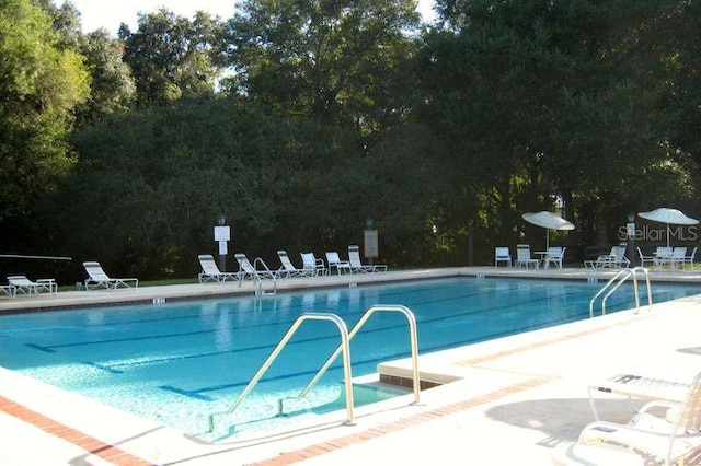 community pool with a patio area