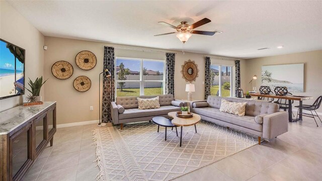 2880 NE 21st Court Rd, Ocala, FL 34470 - living room featuring light tile patterned floors, a ceiling fan, and baseboards