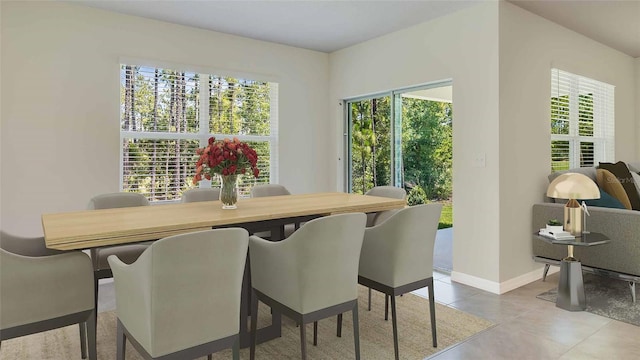 tiled dining space featuring baseboards