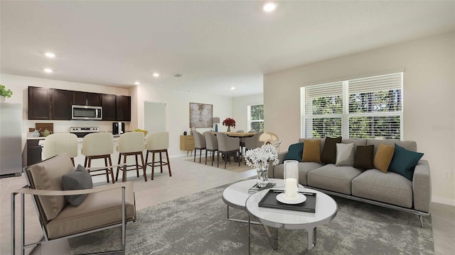 living area featuring baseboards and recessed lighting