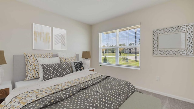 bedroom with carpet flooring and baseboards