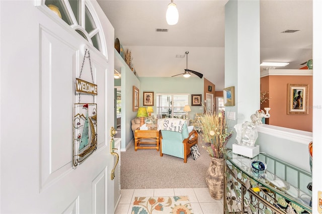 entryway with light carpet and light tile patterned floors