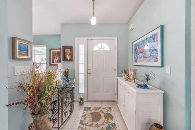 foyer entrance with plenty of natural light and light tile patterned flooring