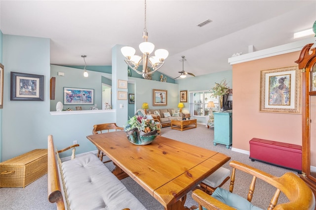 dining area featuring a chandelier, lofted ceiling, carpet floors, and baseboards