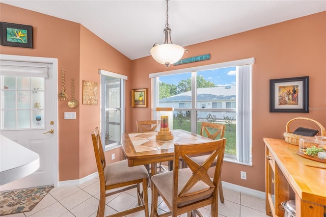 dining space featuring light tile patterned floors and baseboards