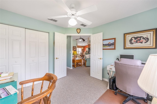 carpeted office featuring a ceiling fan and baseboards