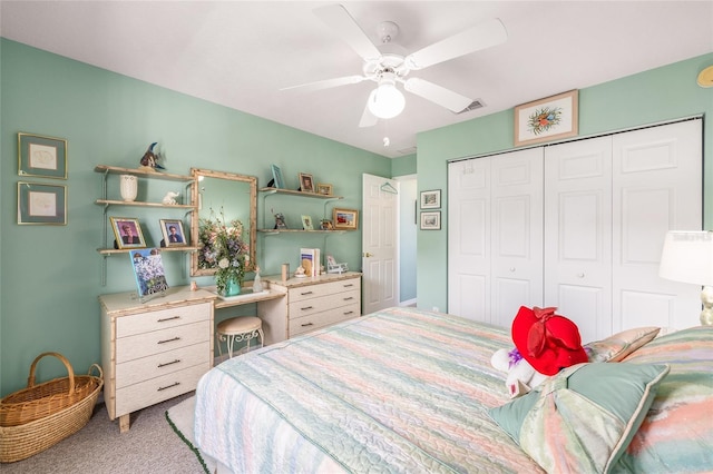 bedroom with light carpet, a closet, and a ceiling fan