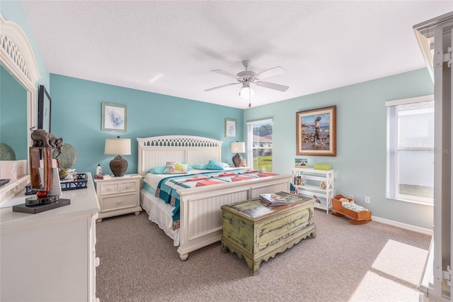 bedroom featuring light carpet, ceiling fan, and baseboards