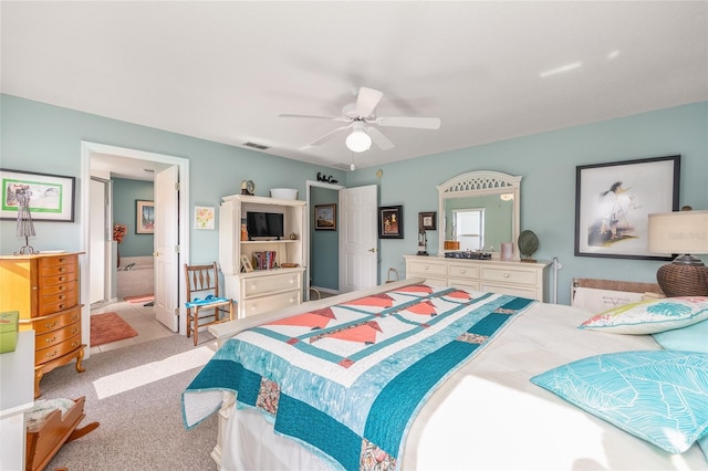bedroom featuring carpet flooring, a ceiling fan, and ensuite bathroom