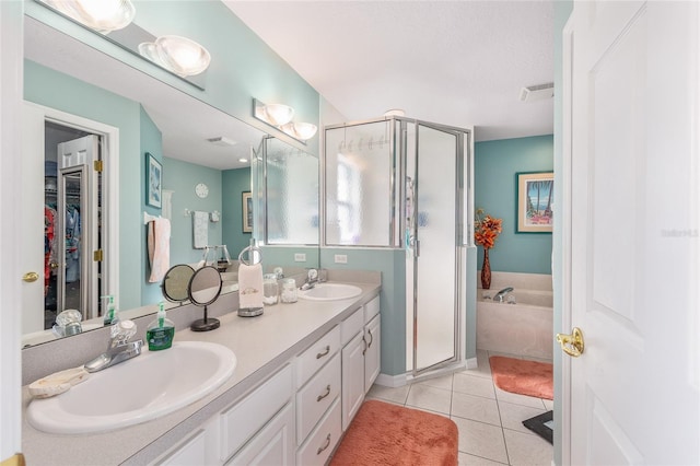 full bath featuring a shower stall, tile patterned floors, double vanity, and a garden tub