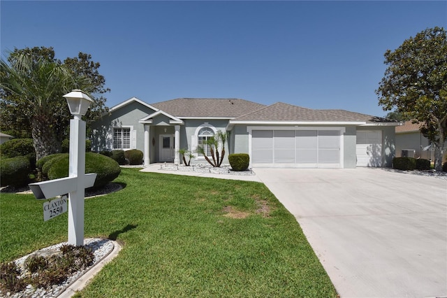 2550 NW 55th Avenue Rd, Ocala, FL 34482 - ranch-style house with a garage, concrete driveway, a front lawn, stucco siding, and roof with shingles