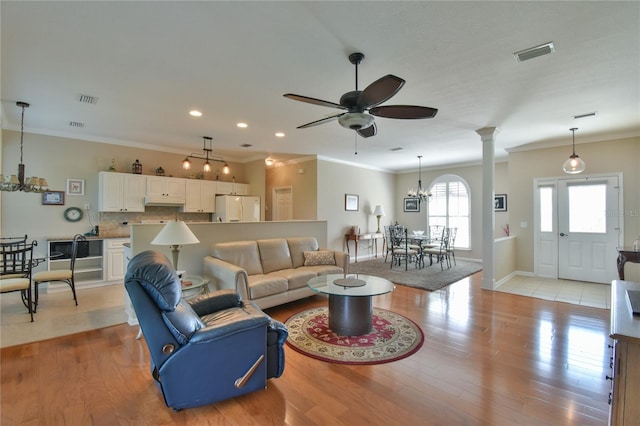 2550 NW 55th Avenue Rd, Ocala, FL 34482 - living room with a chandelier, crown molding, ceiling fan, light wood-style flooring, and recessed lighting