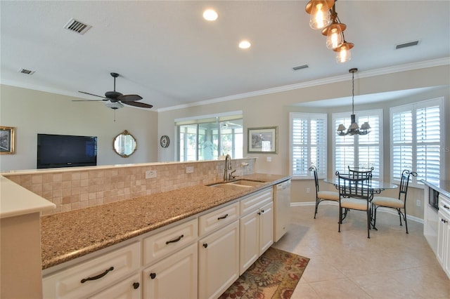 2550 NW 55th Avenue Rd, Ocala, FL 34482 - kitchen featuring a sink, backsplash, white dishwasher, crown molding, and hanging light fixtures
