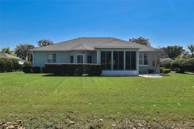 2550 NW 55th Avenue Rd, Ocala, FL 34482 - rear view of property featuring a lawn, a sunroom, stucco siding, and a shingled roof