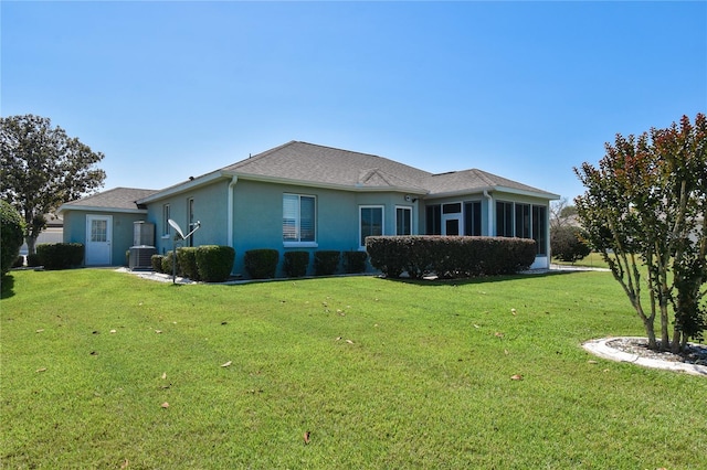 2550 NW 55th Avenue Rd, Ocala, FL 34482 - rear view of property with a yard, central AC, stucco siding, and a sunroom