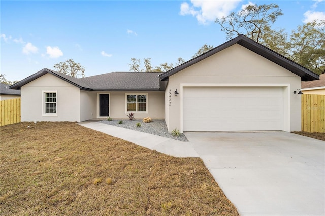 5389 NW 65th St, Ocala, FL 34482 - ranch-style house featuring an attached garage, stucco siding, a shingled roof, and driveway
