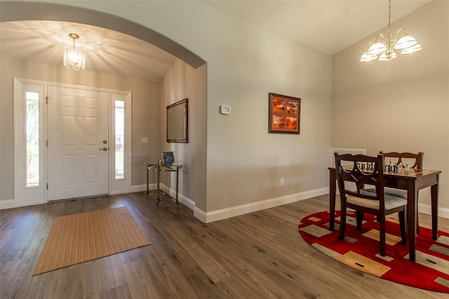 1690 SW 158th Ln, Ocala, FL 34473 - entryway featuring a chandelier, arched walkways, baseboards, dark wood-style flooring, and lofted ceiling
