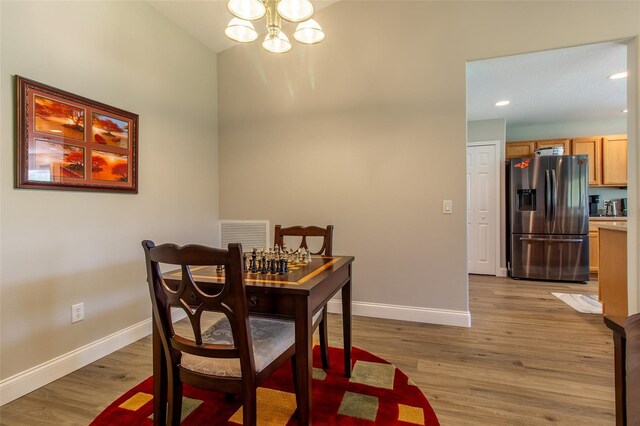 1690 SW 158th Ln, Ocala, FL 34473 - dining area with a chandelier, baseboards, light wood-style flooring, and recessed lighting