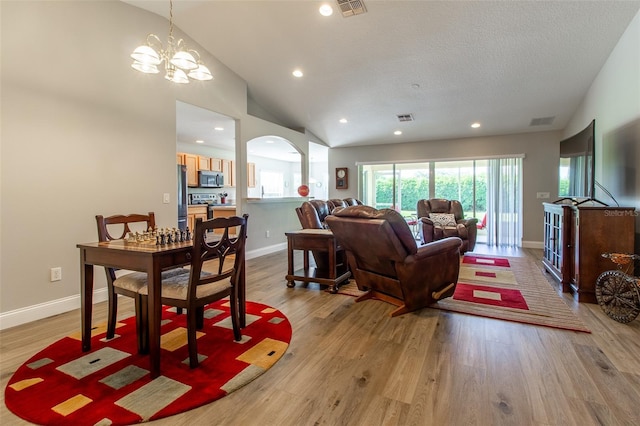 1690 SW 158th Ln, Ocala, FL 34473 - living area with baseboards, light wood-style flooring, a chandelier, recessed lighting, and arched walkways