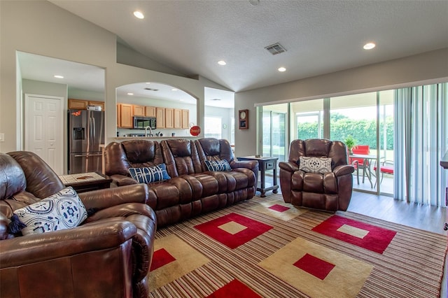1690 SW 158th Ln, Ocala, FL 34473 - living area with recessed lighting, lofted ceiling, a textured ceiling, arched walkways, and light wood-style flooring