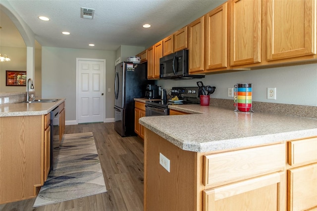 1690 SW 158th Ln, Ocala, FL 34473 - kitchen with black microwave, a sink, electric range, dishwashing machine, and light countertops