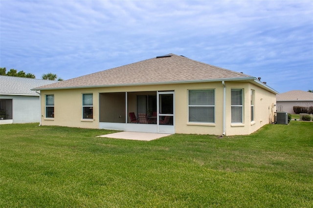 1690 SW 158th Ln, Ocala, FL 34473 - rear view of property featuring central air condition unit, a lawn, stucco siding, a sunroom, and a shingled roof