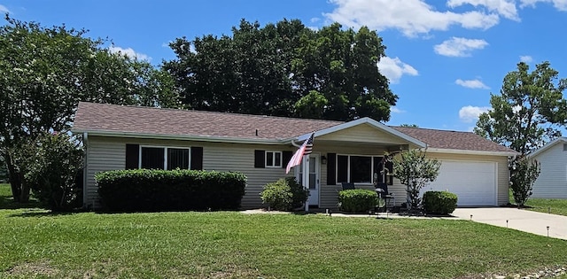 ranch-style home with a front yard, a garage, and concrete driveway